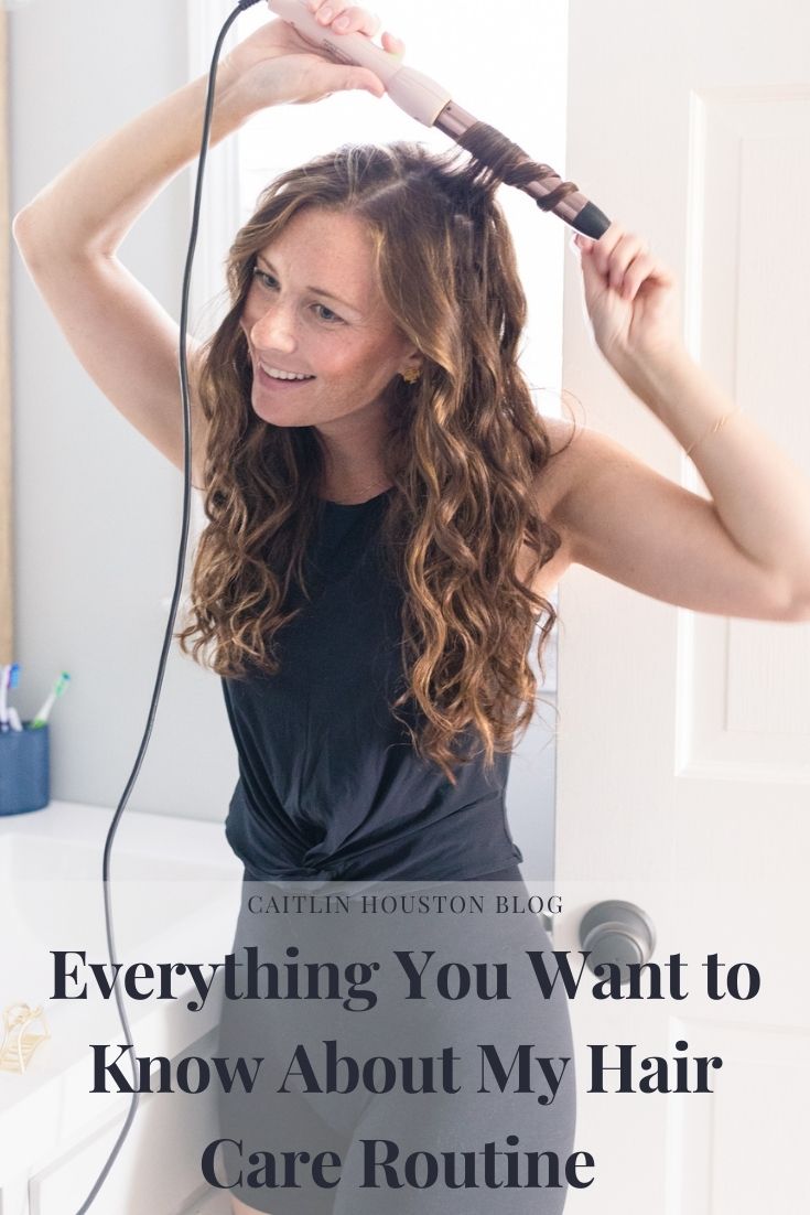woman wearing all black using a wand to wave her hair